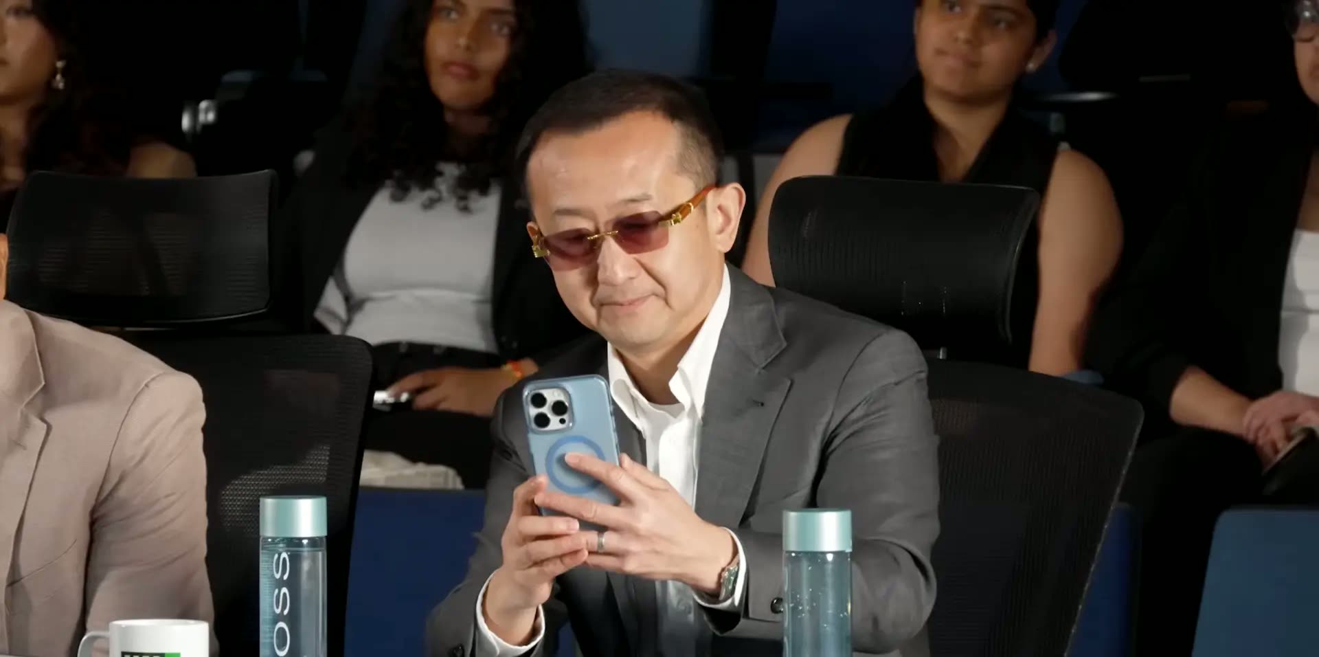 A judge trying on Orys sunglasses in the audience